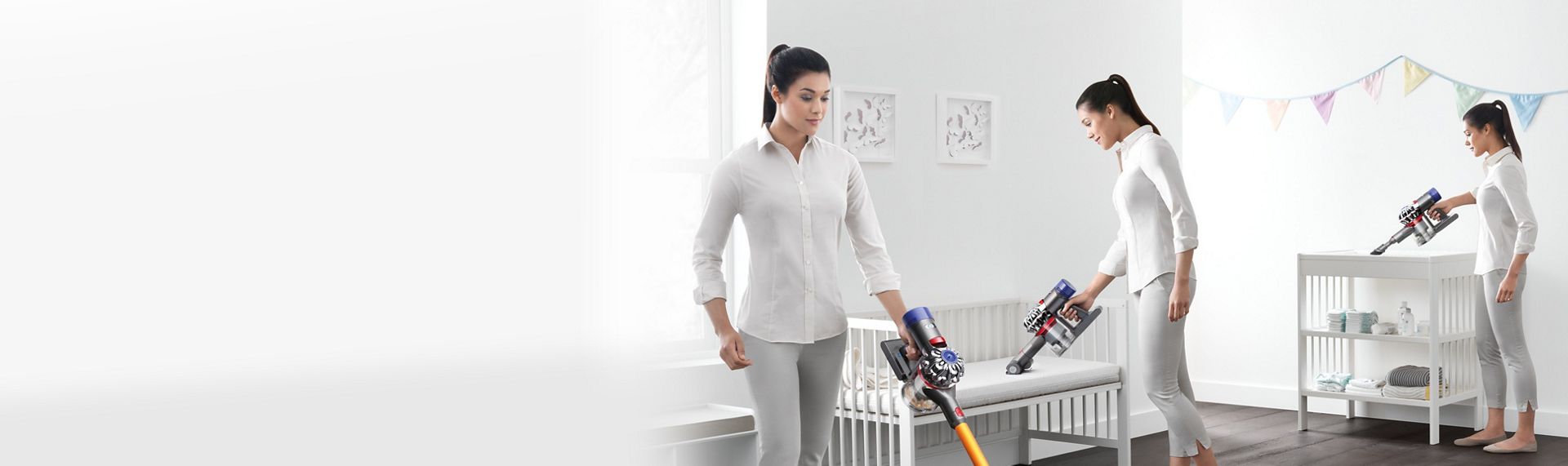 Woman using cord free vacuum and handheld to clean bedroom
