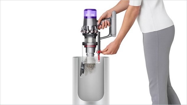 Woman emptying Dyson V11™ vacuum into bin