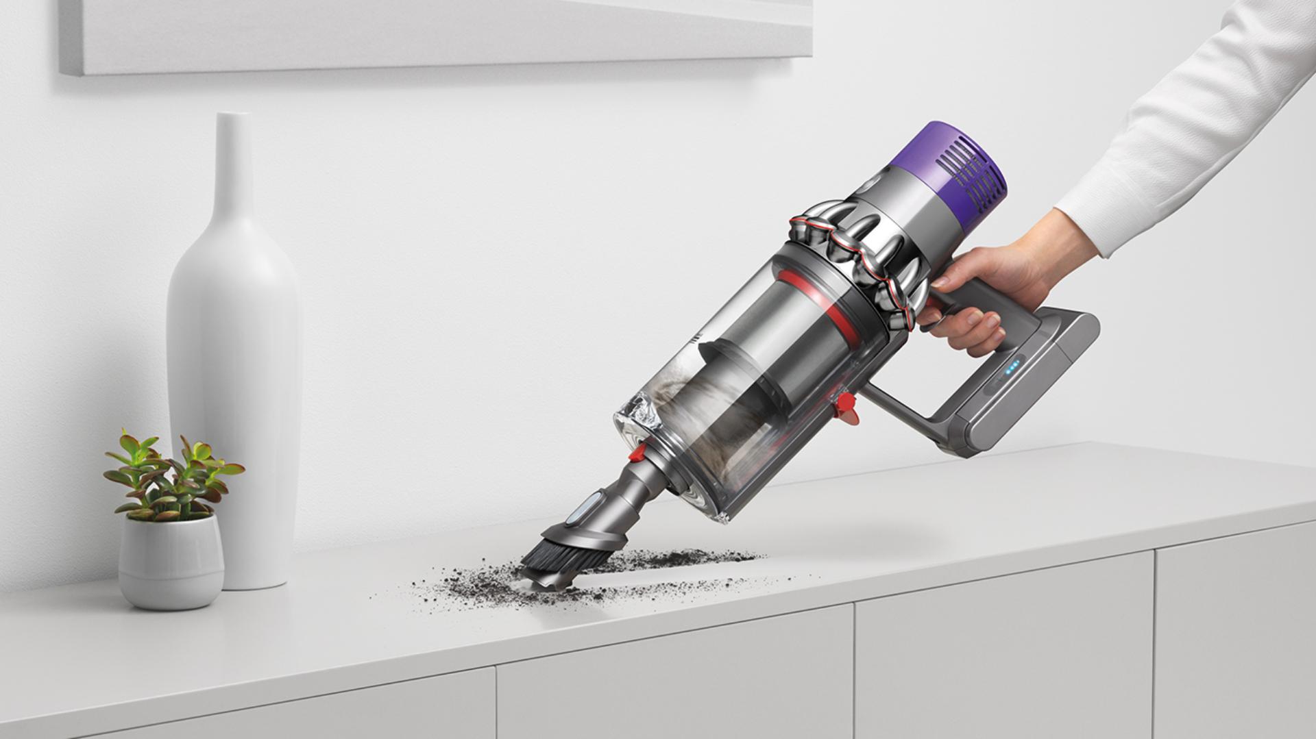 Dyson Cyclone V10™ vacuum in handheld mode cleaning car seat
