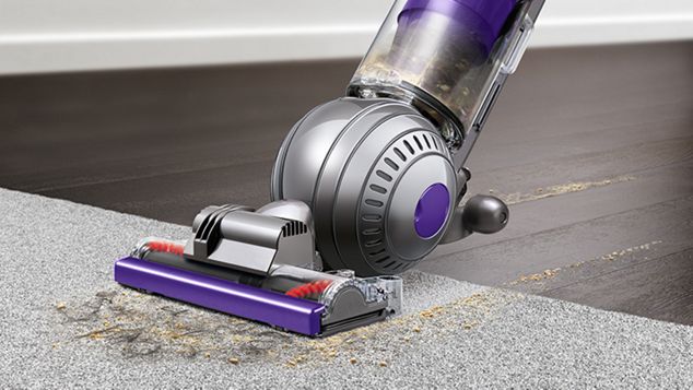 side view of Dyson Ball Animal 2 Pro vacuuming debris off carpet