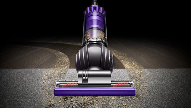 Front view of Dyson Ball Animal 2 Pro vacuuming debris off carpet