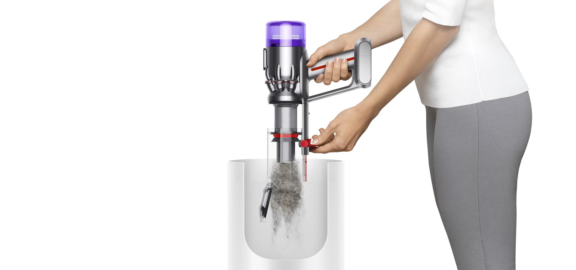 Dyson Humdinger handheld vacuum being emptied into a bin