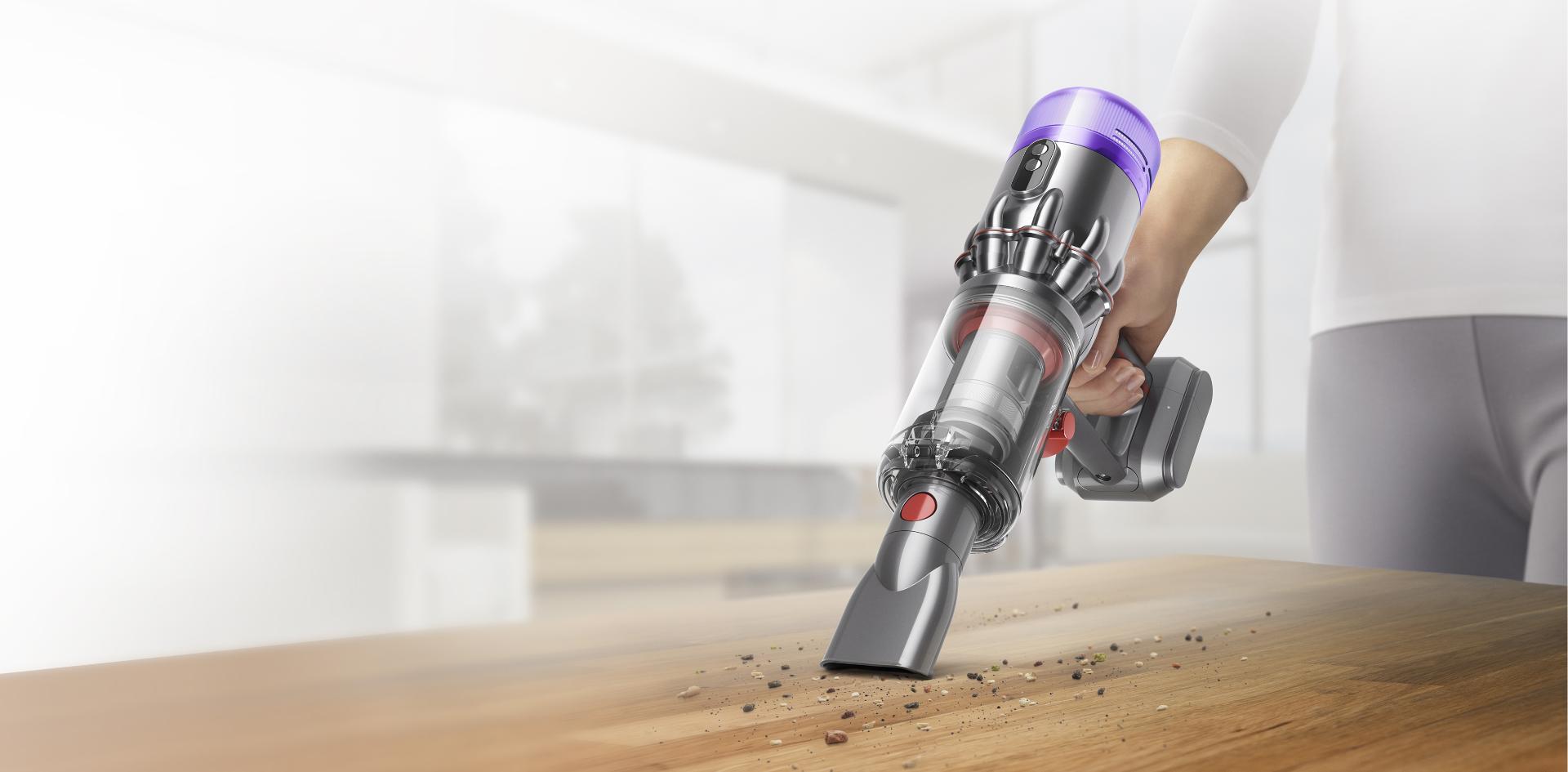 Dyson Humdinger cleaning debris from table