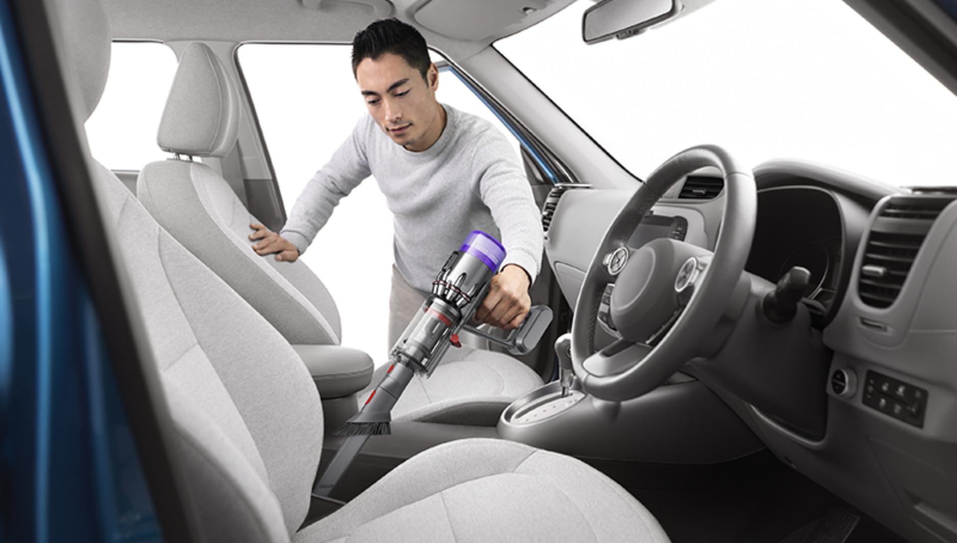 Dyson Humdinger being used to clean the inside of a car