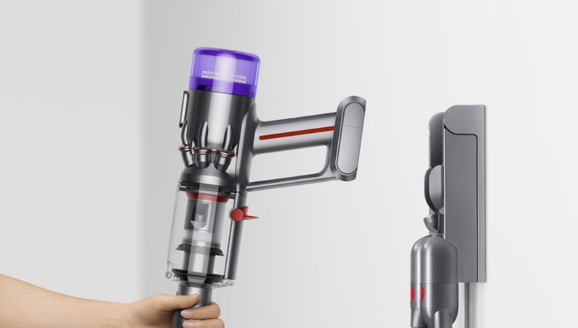 Dyson Humdinger handheld vacuum being put into a wall dock