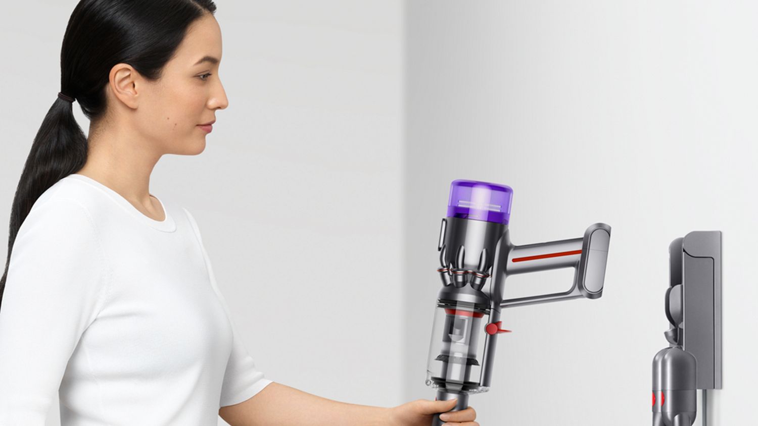 Dyson Humdinger being placed on a wall dock