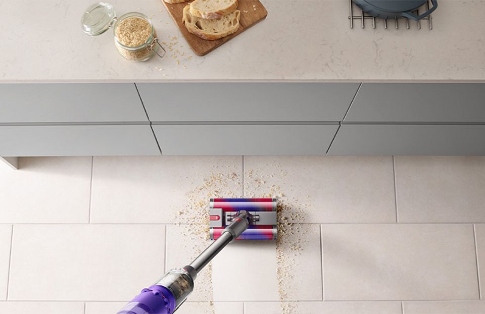 Dyson Omni-glide vacuum in handheld mode cleaning a wall vent Dyson Omni-glide vacuum in handheld mode cleaning a wall vent