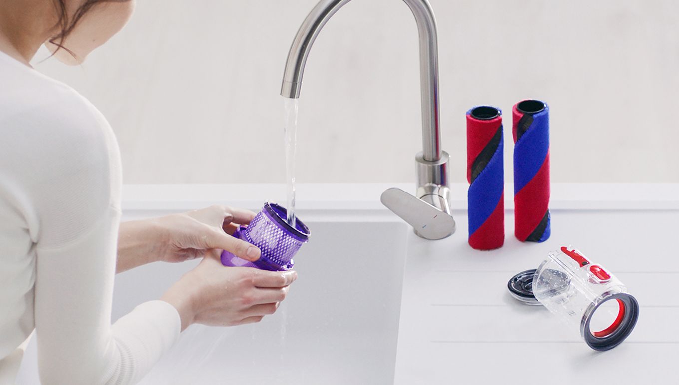 Omni-glide vacuum attachments being cleaned under a tap Omni-glide vacuum attachments being cleaned under a tap