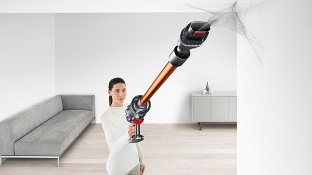 Woman cleaning up high with Dyson V10