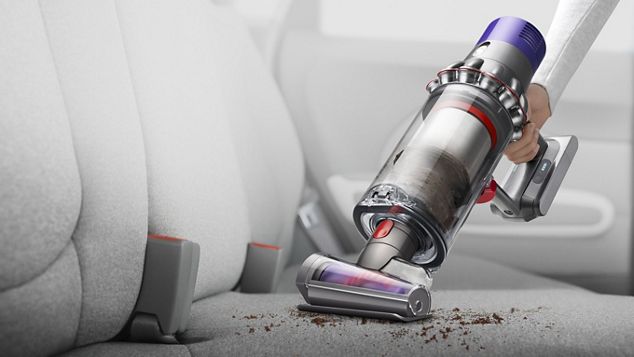 dyson-cyclone-v10-vacuum-handheld-car-interior V10 as a handheld being used to clean car interior