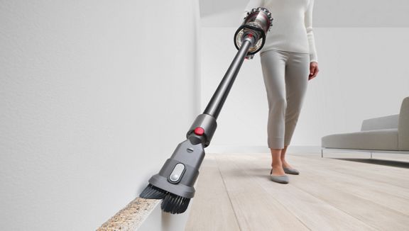 The Dyson Outsize+ vacuum cleaning with the combination tool