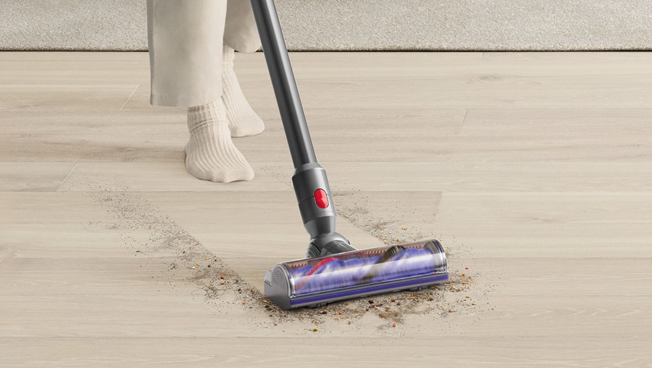 Dyson V8 vacuum cleaning dirt and debris from floor