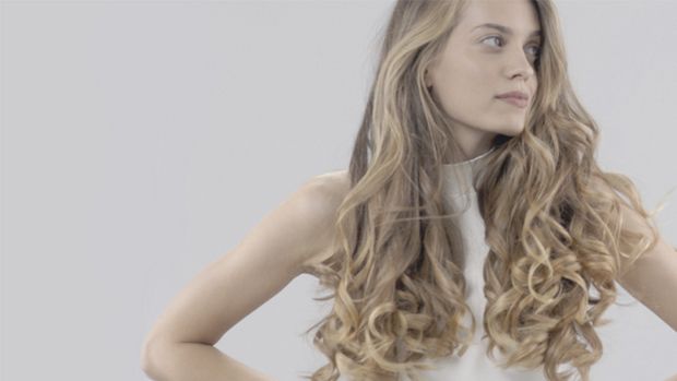 Model wearing a voluminous curly style