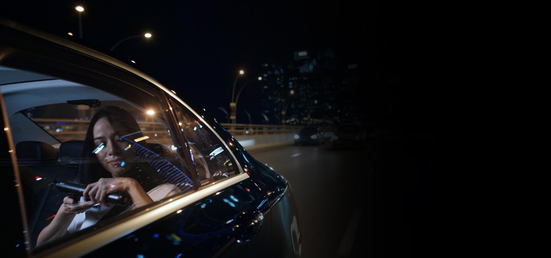 Woman straightening her hair with the Dyson Corrale straightener